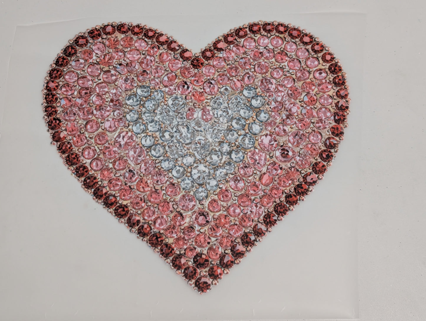 Heart-shaped_design_made_of_pink_and_red_gemstones